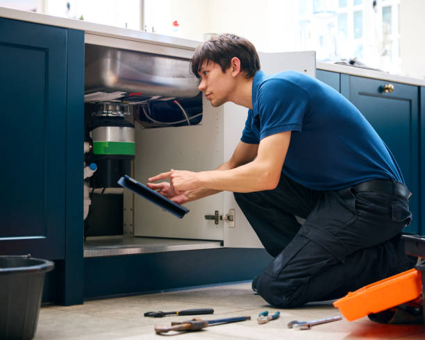 Garbage Disposal Repair Pros technician diagnosing a garbage disposal unit