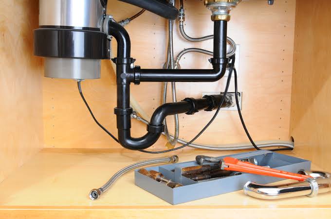 Garbage Disposal Repair Pros technician performing garbage disposal service