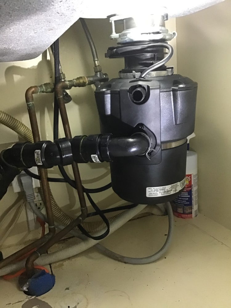 Garbage Disposal Repair Pros technician performing garbage disposal service