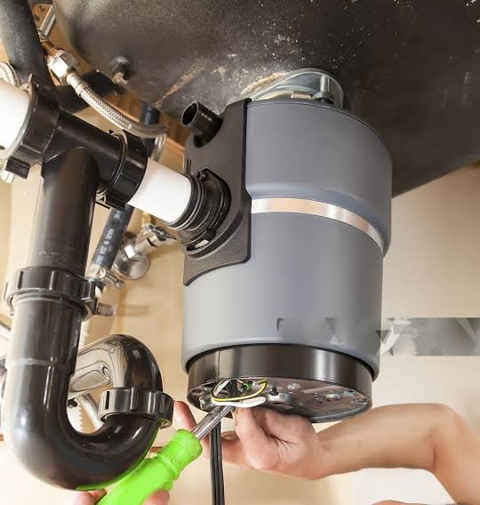 Garbage Disposal Repair Pros technician performing garbage disposal service